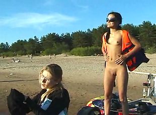 Nudist girls have fun with each other at the beach
